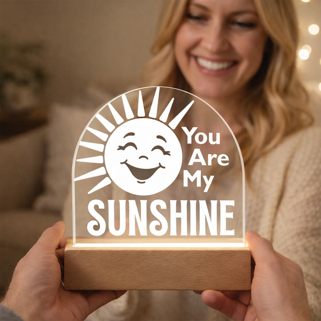 Person smiling at a sunshine plaque as a man is holding it.