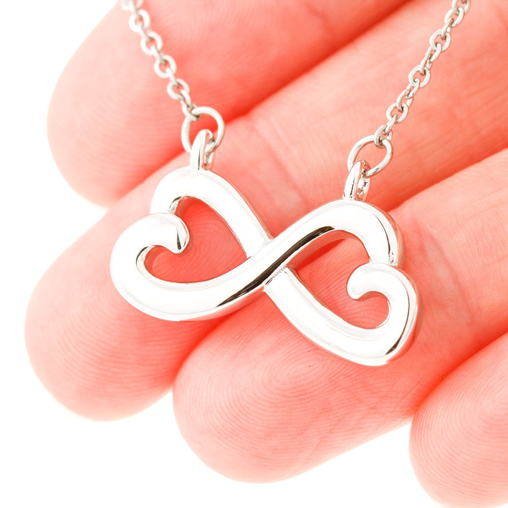 Close up of white gold version of the bestie infinity necklace