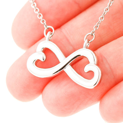 Close up of white gold version of the bestie infinity necklace