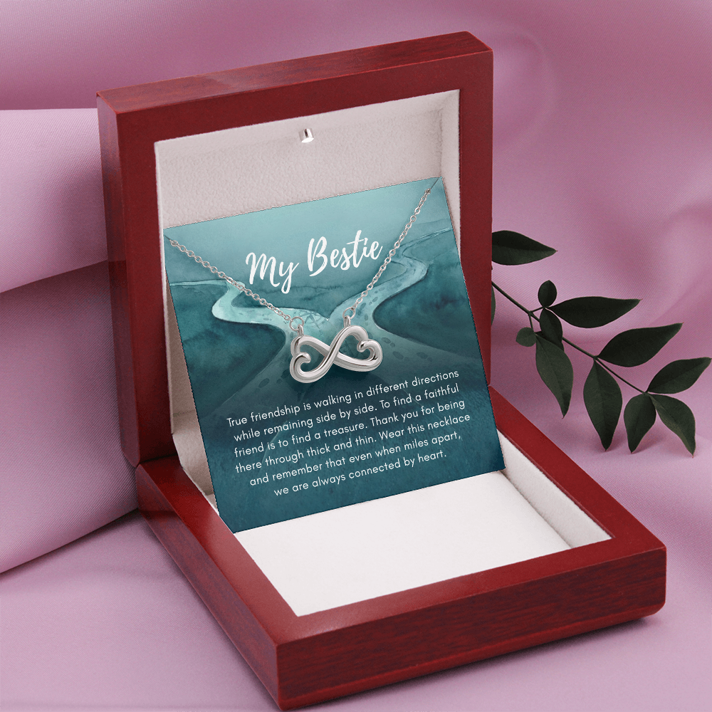 White gold infinity My Bestie necklace on pink background