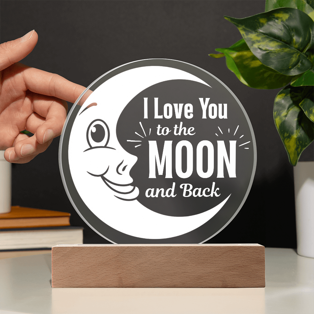 I love you to the moon and back plaque with hand showing transparency against a black wall