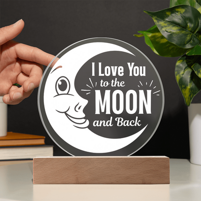 I love you to the moon and back plaque with hand showing transparency against a black wall
