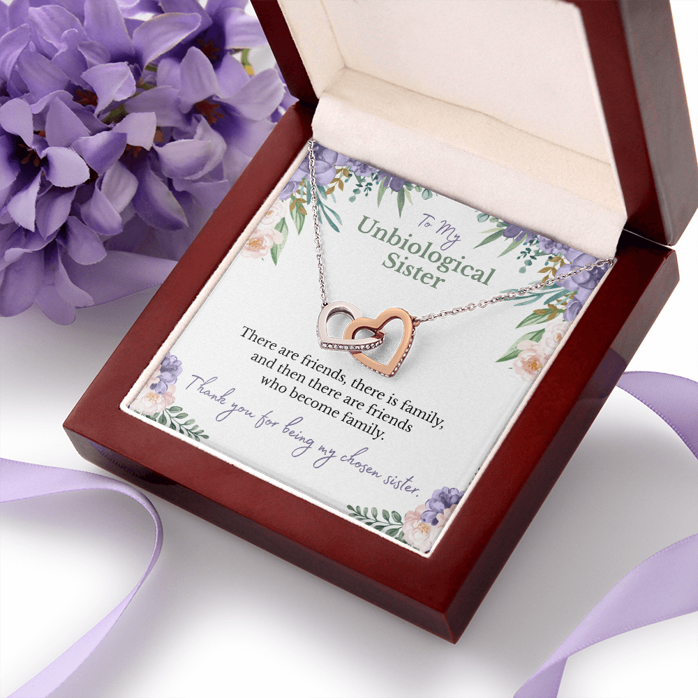 To my unbiological sister message card with rose and white gold hearts necklace in a luxury box with purple flowers and ribbon