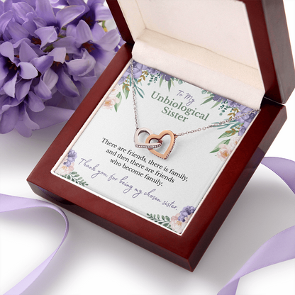 To my unbiological sister message card with rose and white gold hearts necklace in a luxury box with purple flowers and ribbon